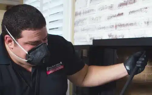 Professional chimney leak inspection on a residential home